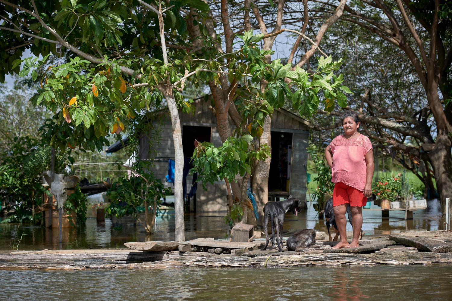 Juscelina Silva Batista, 54, stands in front of her house in the middle of the Amazon River near Santarem, Brazil, April 11, 2019. The Vatican released Pope Francis' postsynodal apostolic exhortation, "Querida Amazonia"